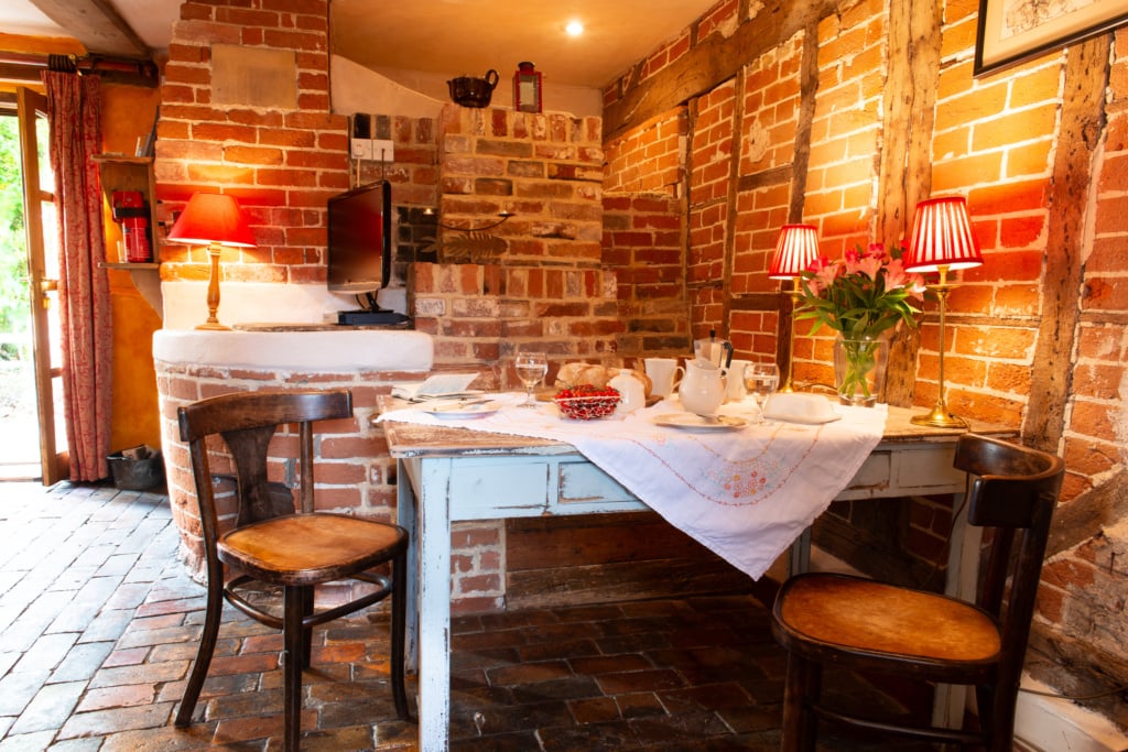 How to Tell a Historic Cottages Story to Guests cosy interior beams Brick floor atmosphere